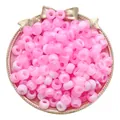 Pink and white two-tone acrylic large-hole barrel beads in a gold tray for DIY crafts - Pink