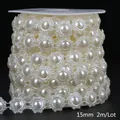 Macro detail of 15mm ABS imitation pearl lace chain on a reel for DIY craft projects - Floral Style / 15mm 2m Pack / Beige