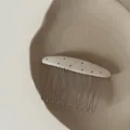 Close-up detail of a minimalist Korean-style oval hair comb with black polka dots - Rice White Oval Black Polka Dot Hair Comb (1#)