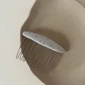 Detail view of a minimalist silver polka dot fabric hair comb on a ceramic plate surface - Champagne Oval Black Polka Dot Hair Comb (2#)