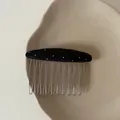 Detailed macro view of an elegant black polka dot hair comb featuring sturdy metal tines - Black Oval White Polka Dot Hair Comb (4#)