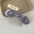 Detail view of a blue satin bow hair comb showing the smooth fabric and metal teeth - Blue Bow Hair Comb / Blue