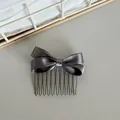 Close-up showing the shimmering gray satin bow detail of this Korean style hair comb - Gray