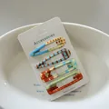 Close-up of 4 patterned hair clips with dots and checks on a white display card. - 4# (Colorful Polka Dot)