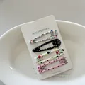 Detail view of four polka dot and striped hair clips on a white display card. - 10# (Black White Polka Dot)
