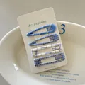 Detailed view of four blue plaid checkered hair clips on white accessories card - 15# (Blue White Plaid)