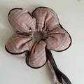 Detailed view of a pink plaid flower-shaped scrunchie hair tie with brown edges - Pink Black Edge Striped Flower Ribbon