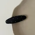 Detailed macro view of a black polka dot oval hair clip with ribbed fabric texture. - Black White Polka Dot Oval Hair Clip (7#)