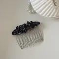 Detail of a black floral fabric-wrapped hair comb with metal tines on a white background. - 1# Black Floral Pleated Oval Hair Comb