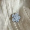Detailed close-up of a French style ice-blue flower hair clip with sparkling rhinestone accents - Flower / Blue