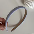 Detailansicht eines hellblauen schmalen Satin Stirnbands mit seidiger Texturoberfläche - Schmales Haarband / Blau