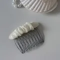 Detail of the elegant cream mesh fabric wrapped around a dark metal hair comb. - 7# Off-White Pleated Oval Hair Comb