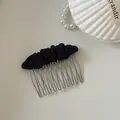 Close-up of elegant black fabric insert hair comb with metal tines on a white desk - 8# Black Pleated Oval Hair Comb