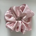 Detailed macro view showing smooth pink satin fabric and white polka dots on a scrunchie - Basic Scrunchie / Pink White Polka Dot