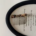 Close-up view of an elegant tortoiseshell acetate bow hair comb on a vintage display board - Hair Comb / Light Leopard Bow Hair Comb