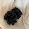 Elegant oversized black fabric rose hair accessory in a French style on a linen background - Rose Hair Tie / Black