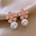 Detailed close-up of French vintage pink flower stud earrings with elegant white pearl drops - Pink