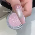 Macro-opname van sprankelende aardbeiroze nagelglitterpoeder in een potje - Aardbeiroze ca. 3g