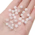 White plum flower shaped glass spacer beads for DIY jewelry making shown in palm - Clear