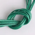 Detailed macro view of 1-2mm green braided waxed cord for DIY handmade jewelry projects - 1mm 15m/Pack / Grass Green