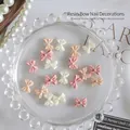 Set of 50 mixed resin bow nail art charms in elegant cream and soft pink pastel tones - 20PCS Mixed