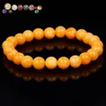 High-quality orange natural stone beaded bracelet with glossy finish on black background. - Yellow Beeswax