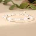 Close-up of white star shell beads and silver metal spacers on a handmade bracelet - White (Four-Point Star Style)