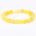 Detailed view of yellow weathered stone beads with intricate white web-like texture - 21cm / 6mm / Yellow Weathered Stone