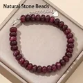 Close-up detail of 5x8mm dark red abacus gemstone beads bracelet with silver clasp - 17cm + Tail Chain / Garnet