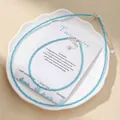 Close-up of faceted turquoise blue stone bead necklace and bracelet set on a decorative plate - Necklace And Anklet Set / Blue Turquoise
