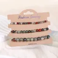 Detailansicht von 3er-Set Naturstein-Armbändern in Erdtönen auf Kraftkarton-Display - Afrikanischer Blutstein