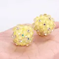 Close-up of yellow polymer clay bubble beads with sparkling rhinestone accents for DIY - Yellow