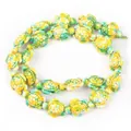 Macro detail of synthetic turquoise turtle beads in green and yellow for DIY jewelry - 14x17mm Sea Turtle Color No. 5 / 22-23 Pieces/String / Yellow-Green