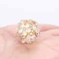 Close-up of a colorful crystal bubble bead with sparkling rhinestones for DIY jewelry - Champagne