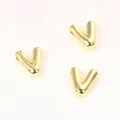 Detailed macro view of three golden copper V-shaped alphabet beads for DIY jewelry making - Letter V / 2 Pcs/Set