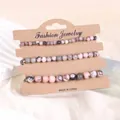 Naturrosa Zebrastein und schwarzes Onyx Perlenarmband Set auf Kraft-Displaykarte - Rosa Zebra Jaspis