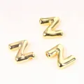 Macro detail of high-quality polished golden copper alphabet letter Z beads for DIY - Letter Z / 2 Pcs/Set