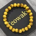 Yellow cat eye glass beaded bracelet with tiger eye effect on black gift box background. - 19cm 8mm / Gold
