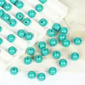 Detailed close-up of synthetic turquoise round beads with holes for DIY jewelry making - 8mm Round / 10 Pack