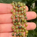 Primer plano de cuentas de piedras preciosas facetadas verde oliva para collares y pulseras - 6mm / Jade Canadiense