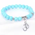 Macro view of blue turquoise beads and silver Om symbol charm on bracelet - 8mm Beads Om Pendant Style (B0027) / 19cm / Imitation Blue Turquoise