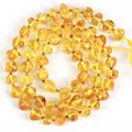 Detaillierte Makroansicht lichtdurchlässiger, unregelmäßiger Bernstein-Natursteinperlen für DIY - 5-6mm (ca. 55 Stück/Packung) / Glatt Gelb