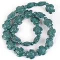 Macro detail of synthetic turquoise stone beads in sea turtle shape for DIY jewelry. - 14x17mm Shiny Sea Turtle / 22-23 Pieces/String / Shiny Ink Green
