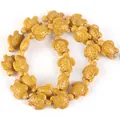 Detailed macro shot of yellow synthetic turquoise turtle beads for DIY jewelry making - 14x17mm Shiny Sea Turtle / 22-23 Pieces/String / Shiny Egg Yellow