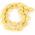 Macro detail of cream synthetic turquoise turtle beads for DIY handmade jewelry crafting - 14x17mm Shiny Sea Turtle / 22-23 Pieces/String / Shiny Wheat Yellow