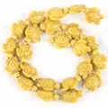 Detail view of yellow turtle-shaped synthetic turquoise beads for DIY jewelry making. - 14x17mm Shiny Sea Turtle / 22-23 Pieces/String / Shiny Light Honey Yellow