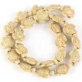 Detailed view of beige synthetic turquoise sea turtle beads for DIY jewelry making - 14x17mm Shiny Sea Turtle / 22-23 Pieces/String / Shiny Ivory Yellow