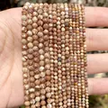 Detailed view of faceted natural stone beads in earthy tones showing textures and scale. - 2mm Approx 170 Pieces / Jasper