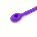 Macro view of purple silicone cable tie showing textured ridges and rounded locking hole - 1 Piece / Purple