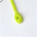 Close-up detail of a 21cm thick neon green flexible silicone cable tie for DIY use - 1 Piece / Green